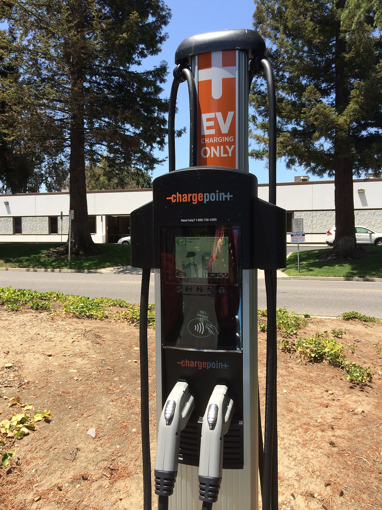 Dual-head public EV charging station showing J1772 connectors used by Level 2 chargers — Bano Electrical Services Ltd