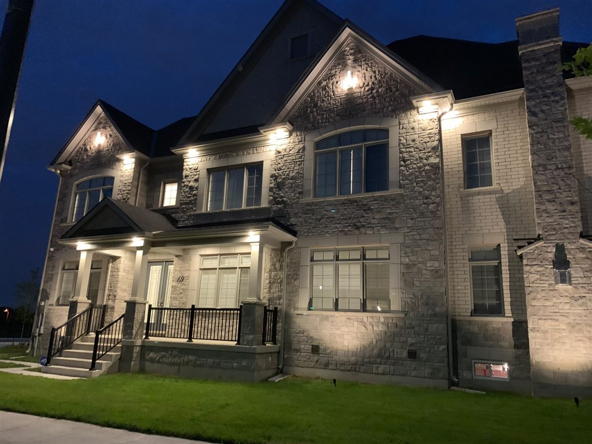 Custom home exterior lighting at night — Brampton